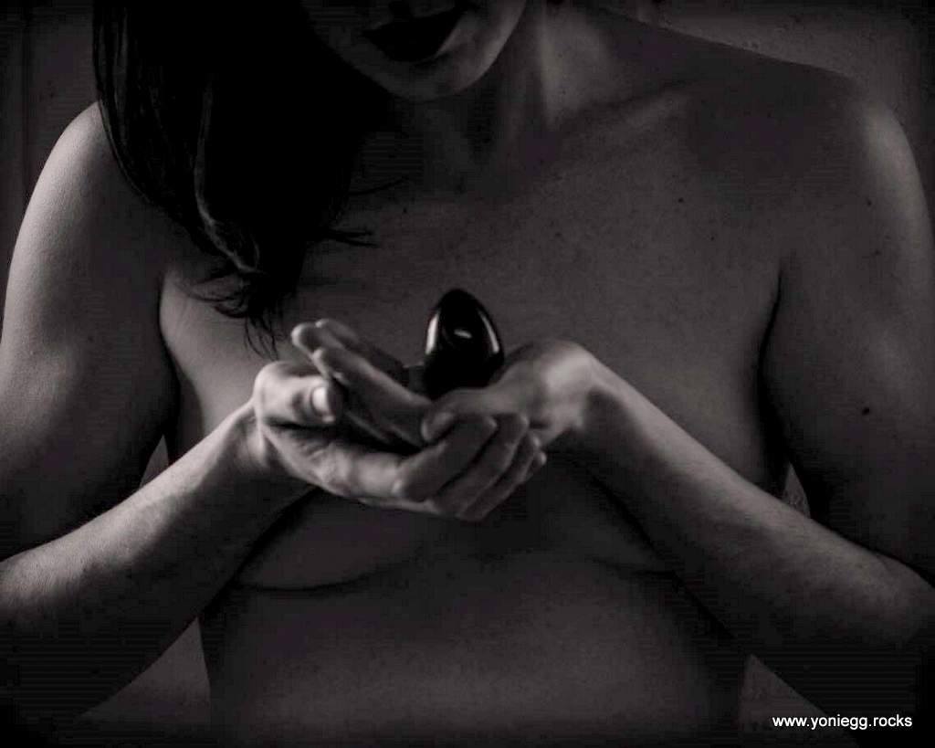 black egg in front of a woman